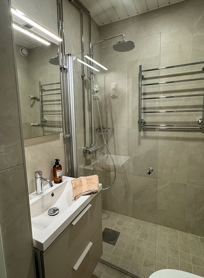 Uusi suihkuseinä, pyyhekuivain ja selkeälinjainen allaskaappi lisäävät toimivuutta pienessä tilassa.